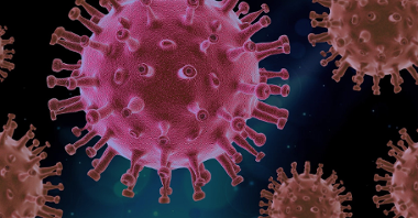 Grafika przedstawiająca różowe cząsteczki koronawirusa na niebieskim tle